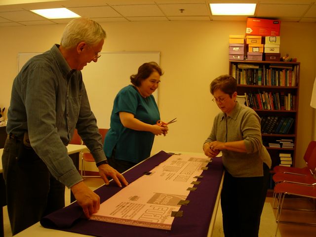 Chuck Hurwitz, Sally Huebscher and Ronne Harris assembling display board.